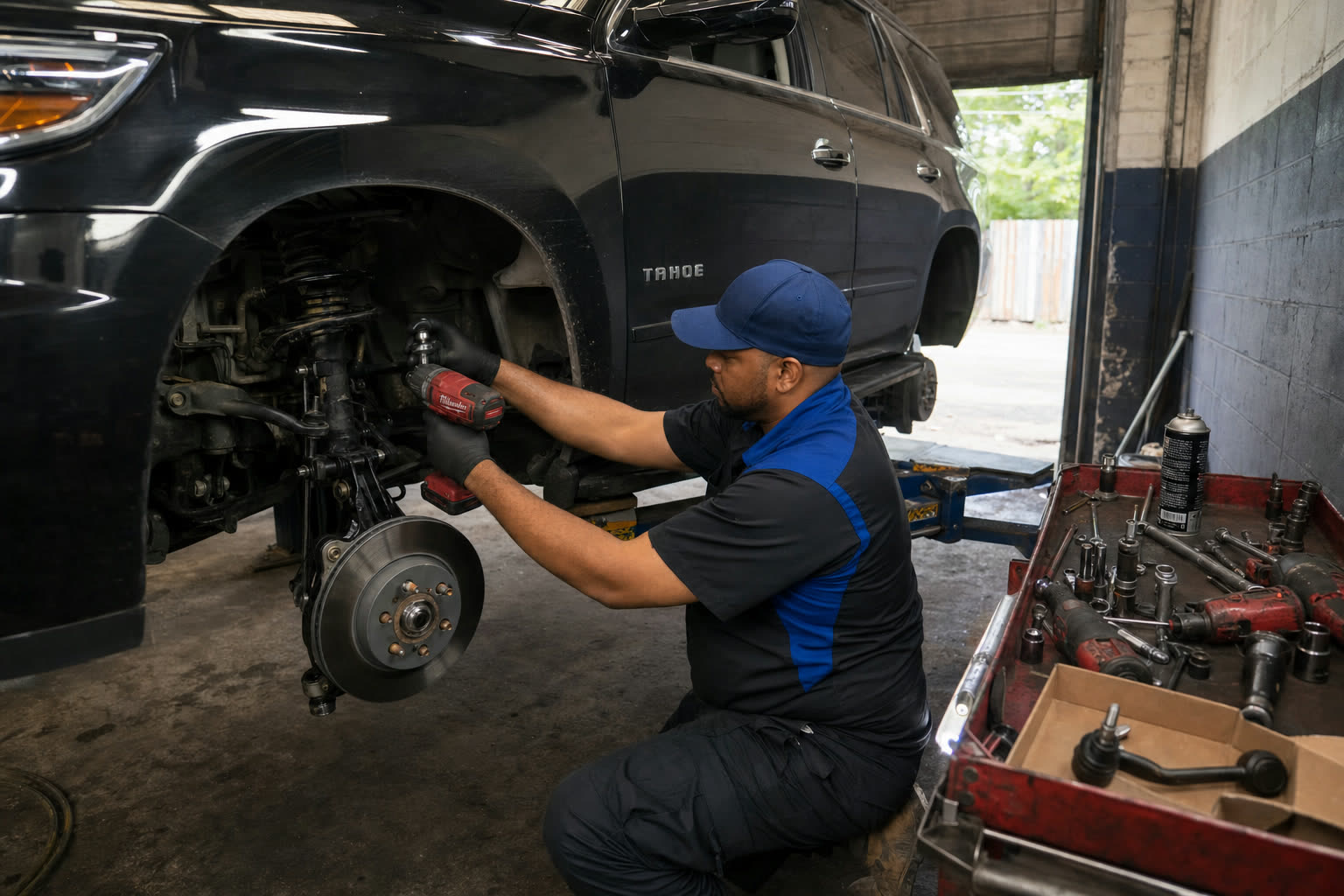 Mechanic performing suspension repair at Tees Auto Repairs in Detroit, MI